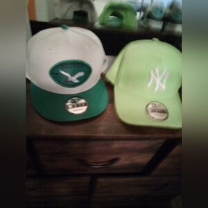 Fitted Eagles and NY new era hats excuse blurry picture camera is compromised